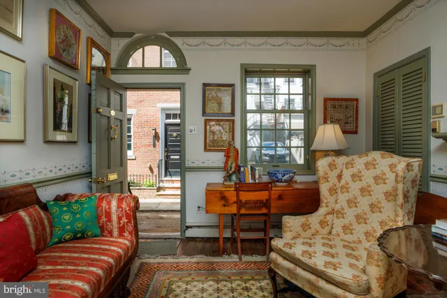 a living room with furniture fireplace and a window