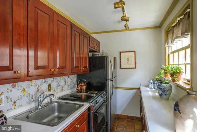 a kitchen with stainless steel appliances granite countertop a sink stove and cabinets