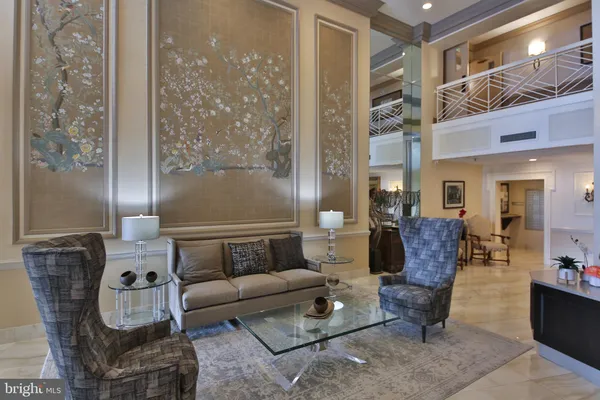 a living room with furniture a lamp and a chandelier
