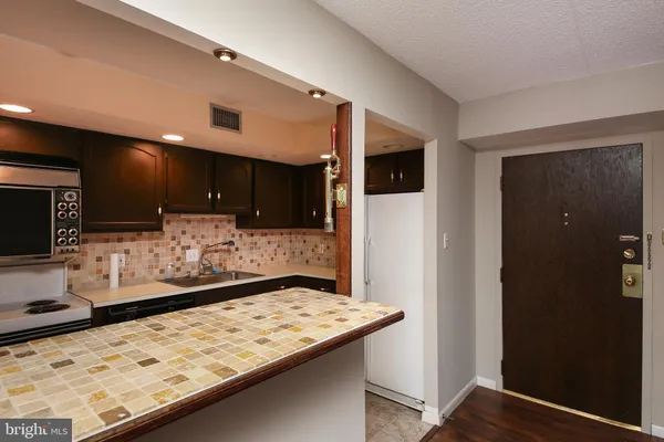 a kitchen with stainless steel appliances kitchen island granite countertop a sink and cabinets
