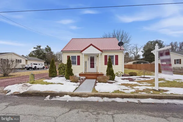 a view of a house with snow on the road