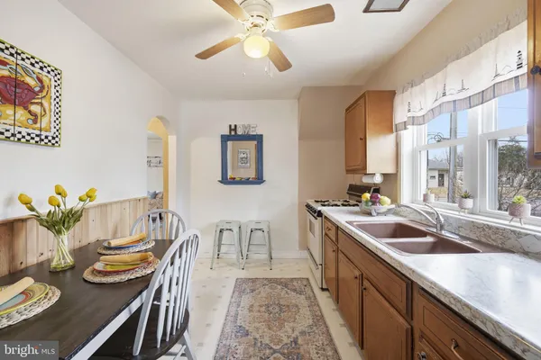 a kitchen with stainless steel appliances granite countertop a kitchen island a stove and a sink