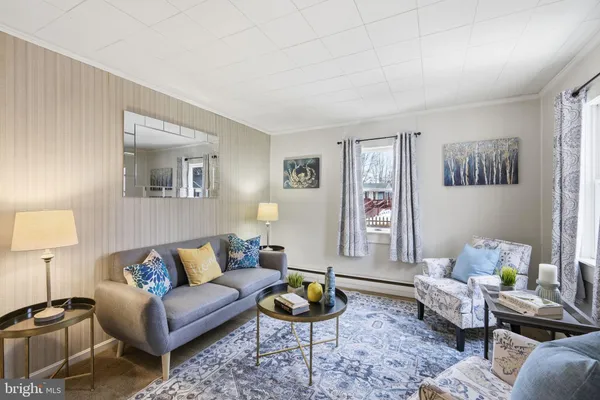 a living room with furniture and a lamp
