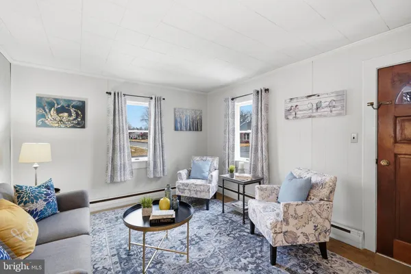 a living room with furniture a rug and a window