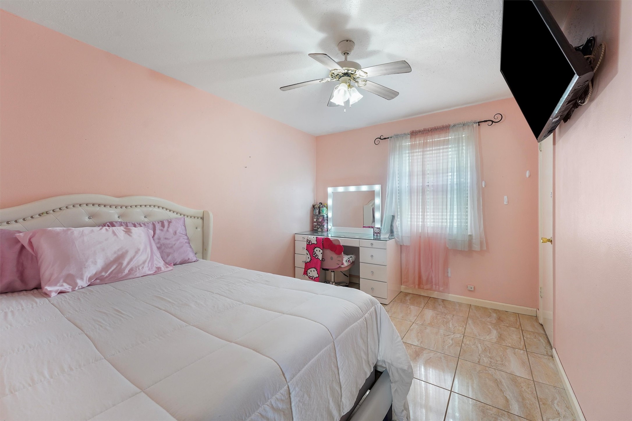 730 Stonyridge Street Channelview, TX 77530 - Photo 16 of 26 a bedroom with a bed and a chandelier