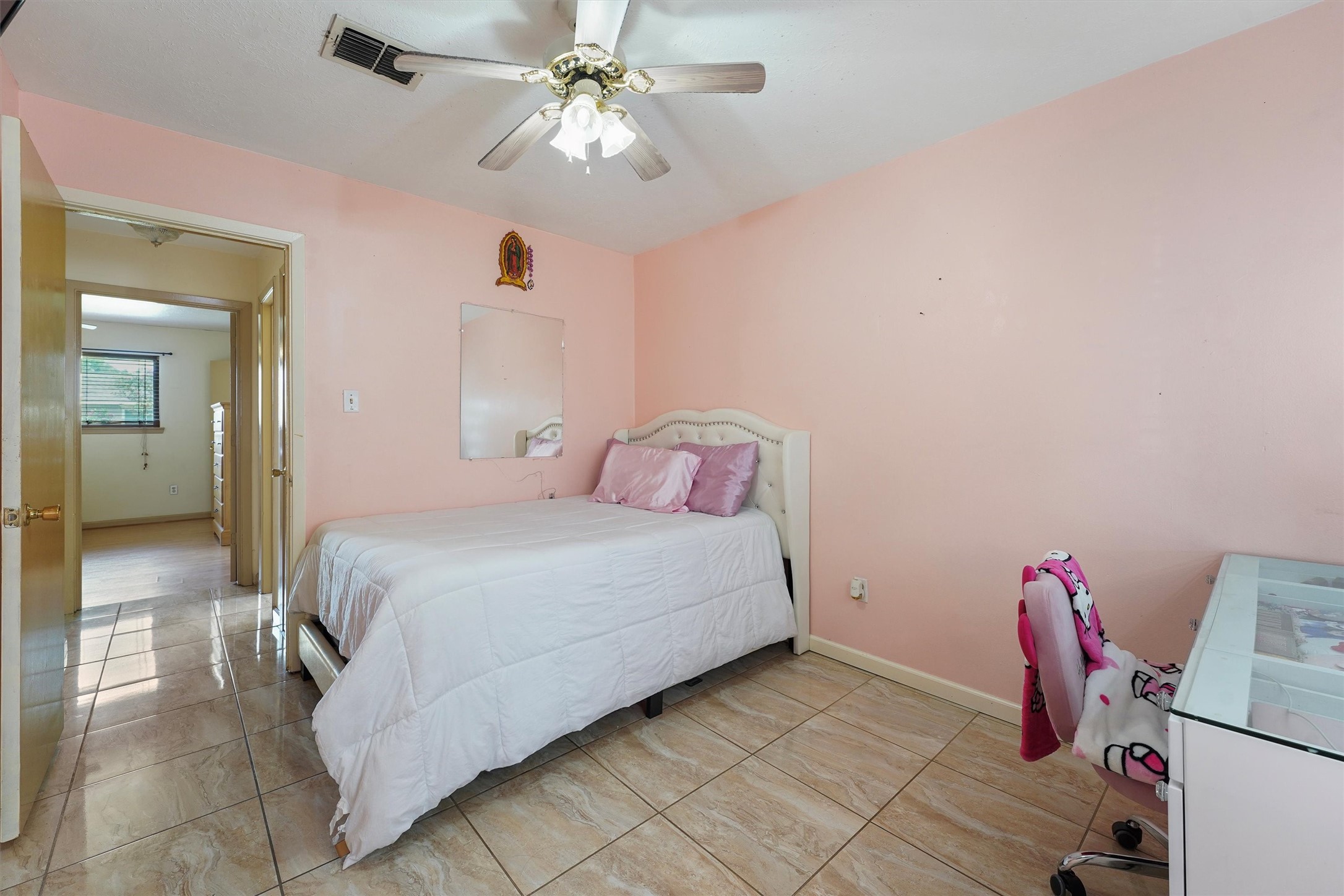 730 Stonyridge Street Channelview, TX 77530 - Photo 17 of 26 a bedroom with a bed and a chandelier