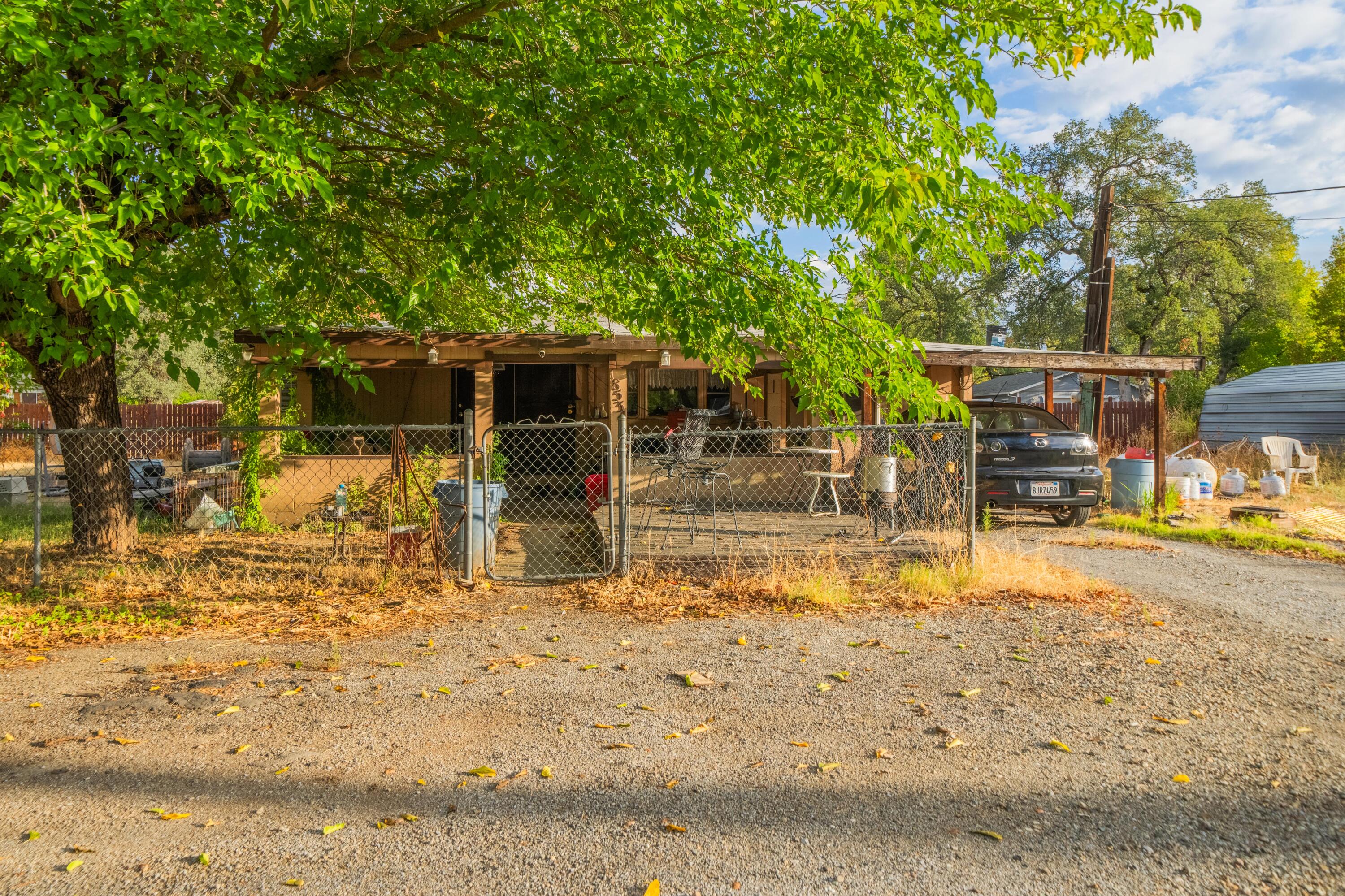 18534 Candy Lane Redding, CA 96003 - Photo 1 of 20 a view of a yard with wooden fence
