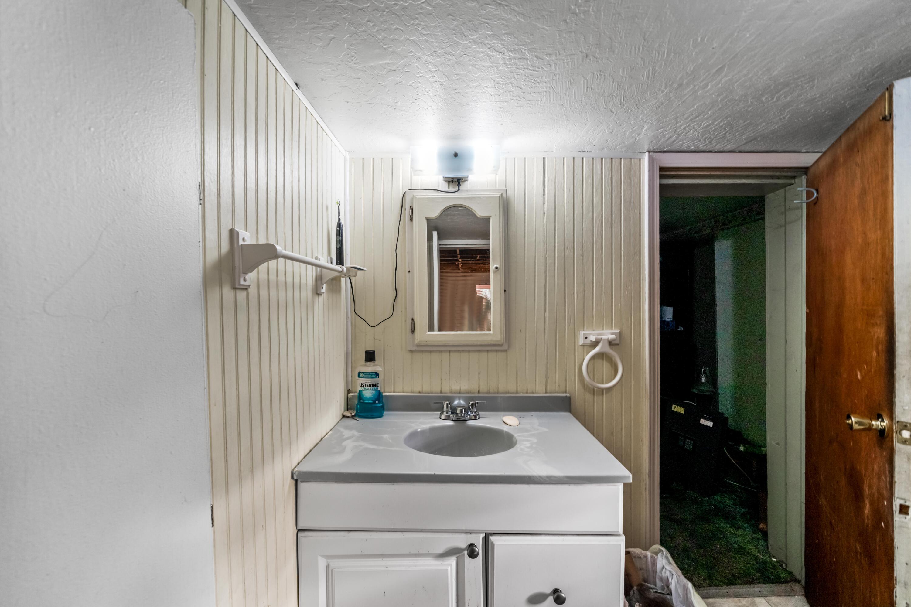 18534 Candy Lane Redding, CA 96003 - Photo 12 of 20 a bathroom with a sink and a mirror