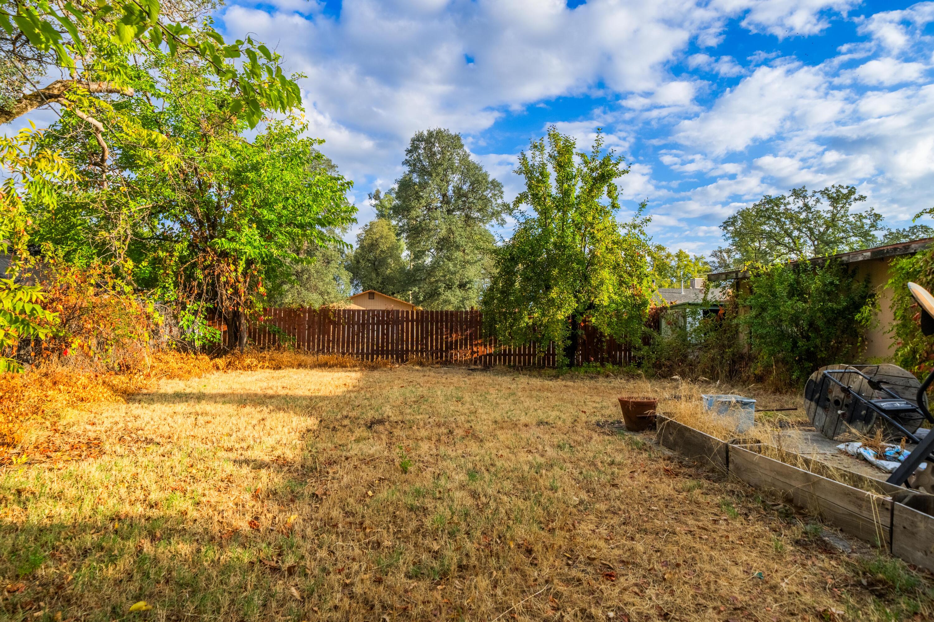 18534 Candy Lane Redding, CA 96003 - Photo 15 of 20 a backyard of a house with lots of green space
