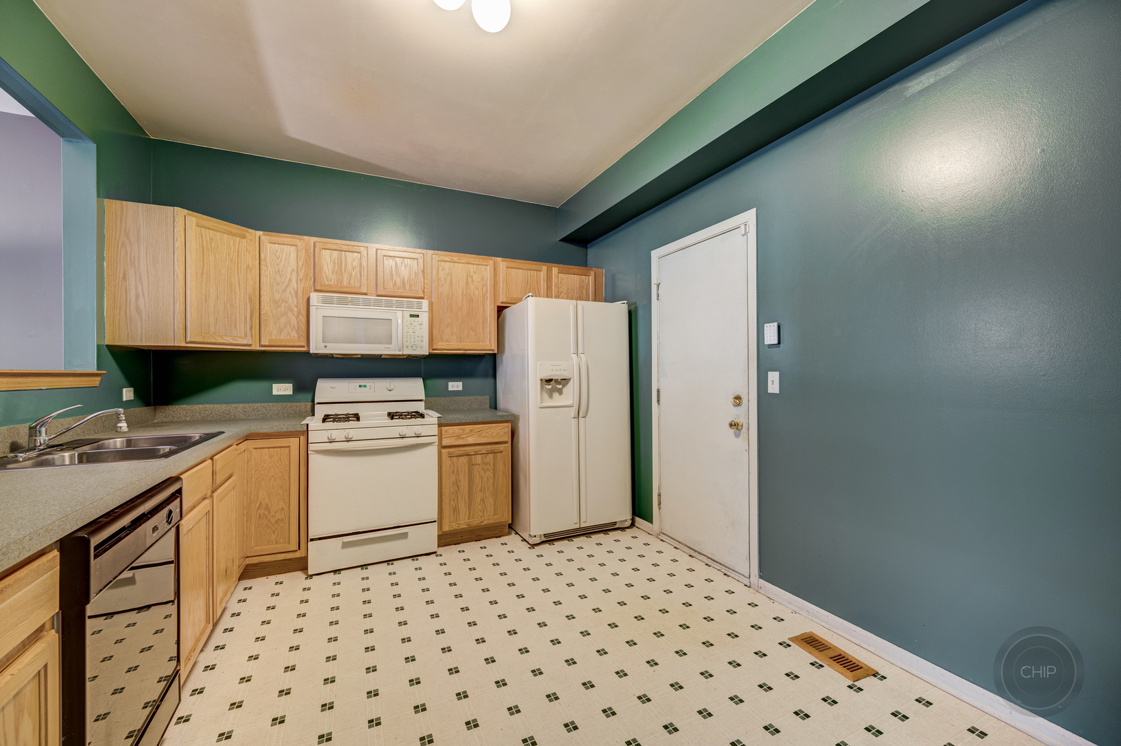 752 County Line Road Aurora, IL 60502 - Photo 13 of 30 a kitchen with a refrigerator and cabinets