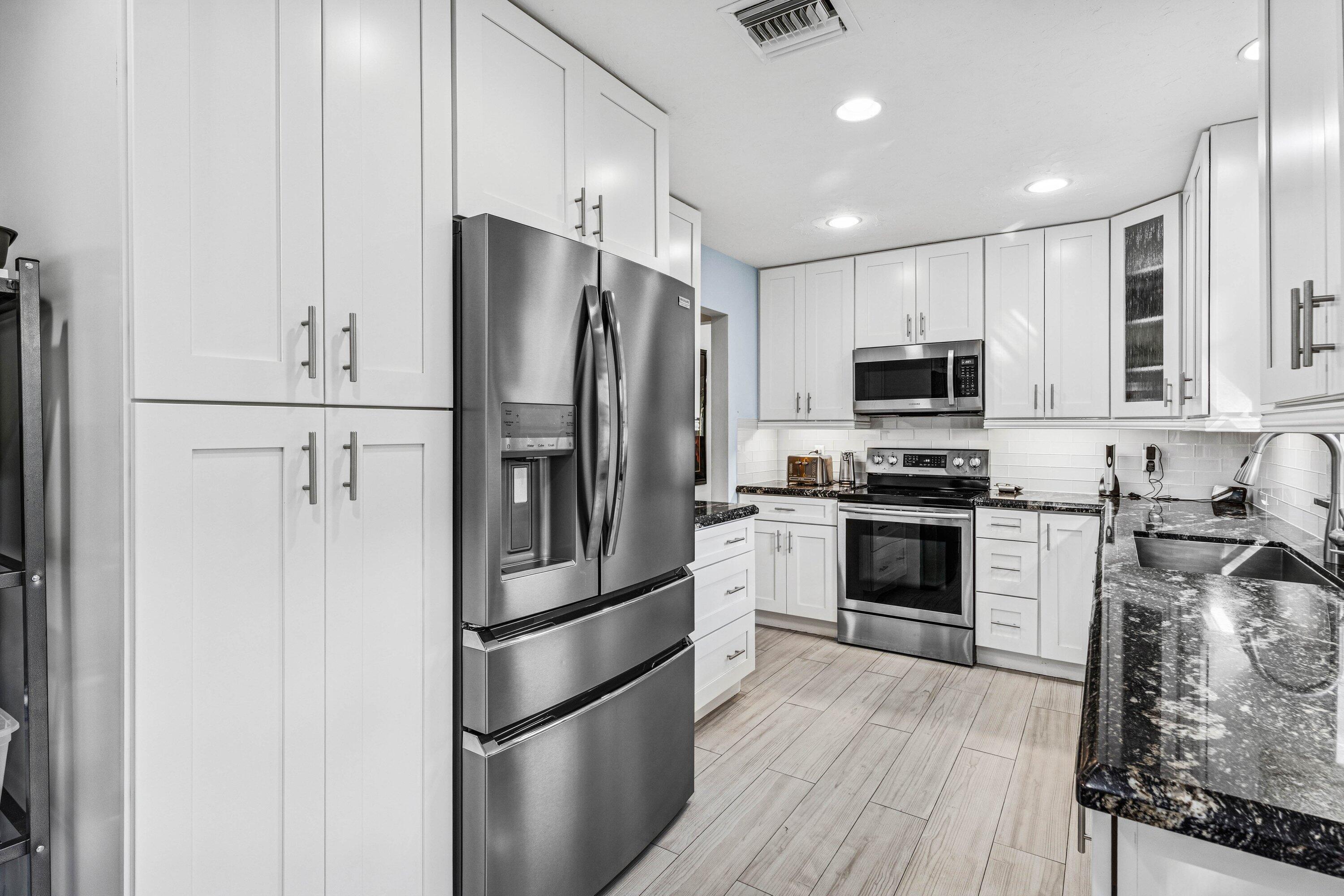 21720 Arriba Real, Unit 37B Boca Raton, FL 33433 - Photo 15 of 41 a kitchen with stainless steel appliances a refrigerator sink and microwave