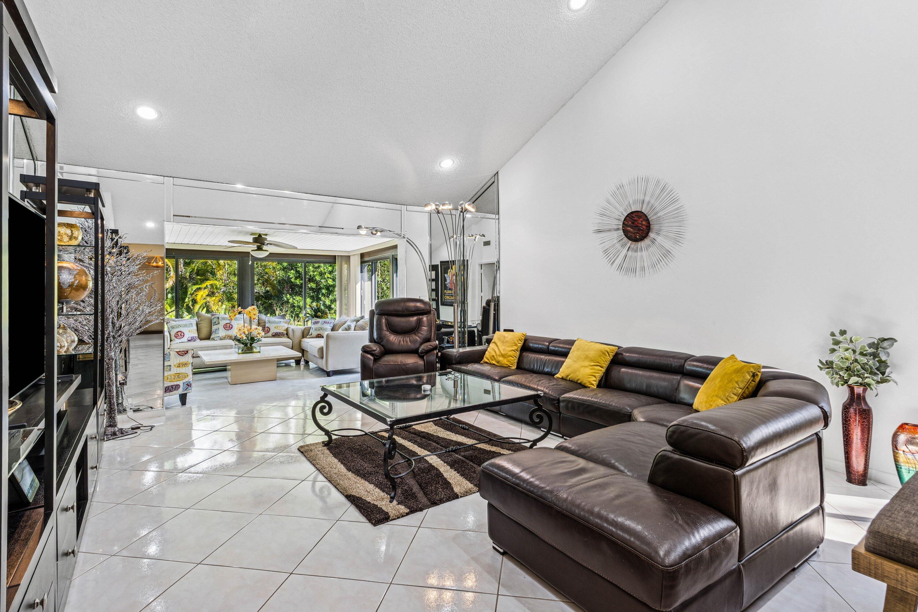 21720 Arriba Real, Unit 37B Boca Raton, FL 33433 - Photo 19 of 41 a living room with furniture a flat screen tv and a large window