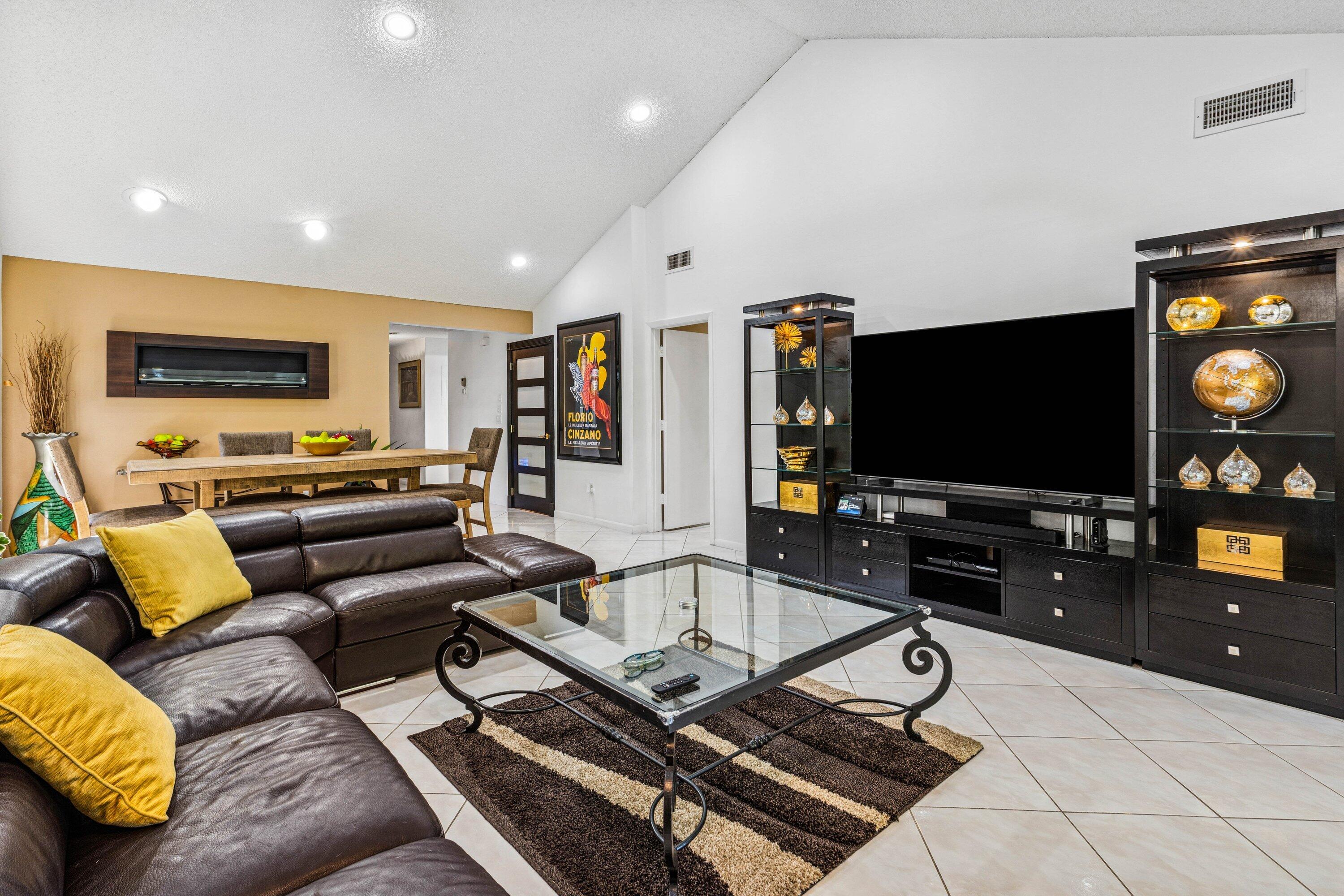 21720 Arriba Real, Unit 37B Boca Raton, FL 33433 - Photo 22 of 41 a living room with furniture and a flat screen tv