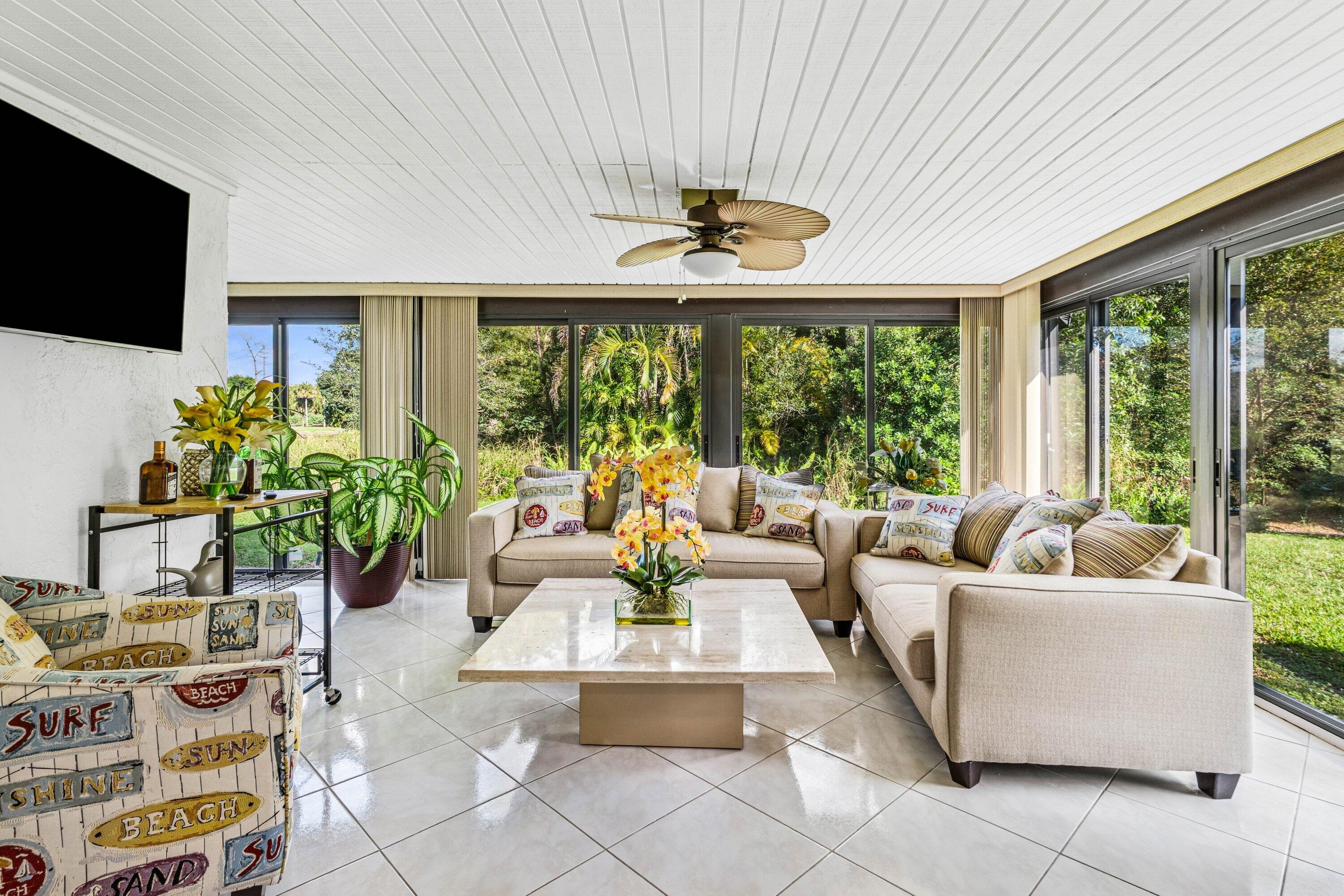 21720 Arriba Real, Unit 37B Boca Raton, FL 33433 - Photo 23 of 41 a living room with patio furniture and a flat screen tv