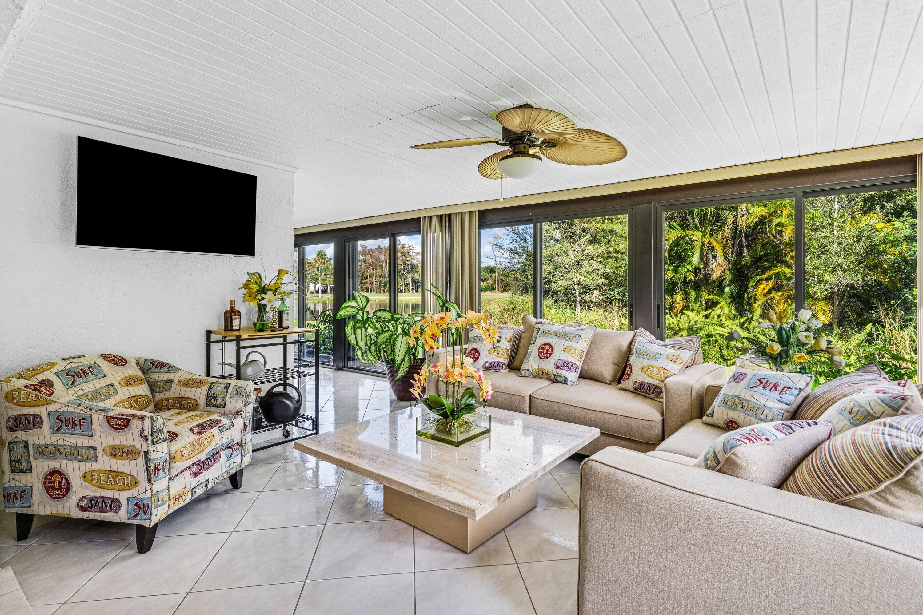 21720 Arriba Real, Unit 37B Boca Raton, FL 33433 - Photo 24 of 41 a living room with furniture a flat screen tv and a large window