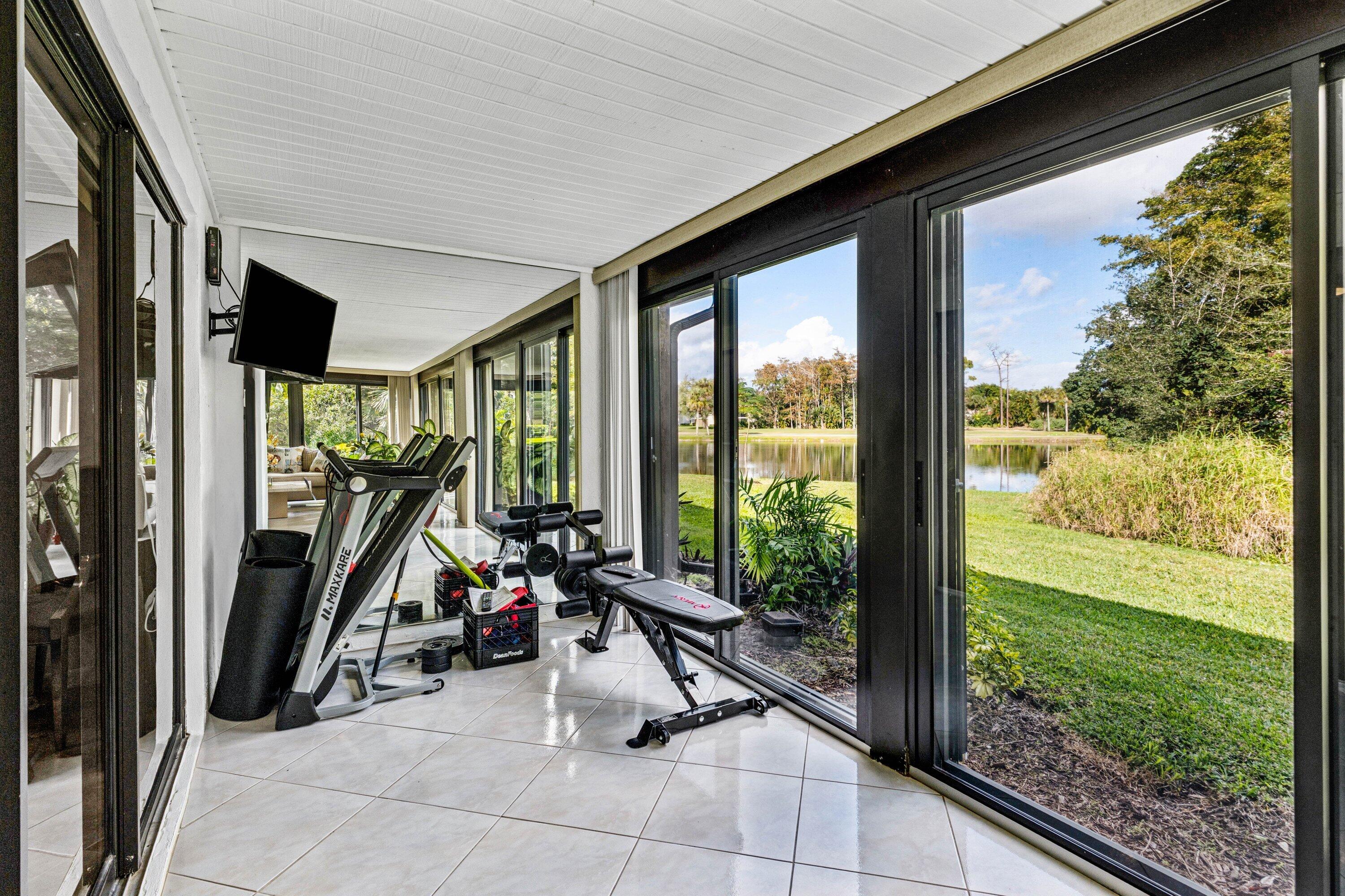 21720 Arriba Real, Unit 37B Boca Raton, FL 33433 - Photo 25 of 41 a view of a porch with furniture and floor to ceiling window