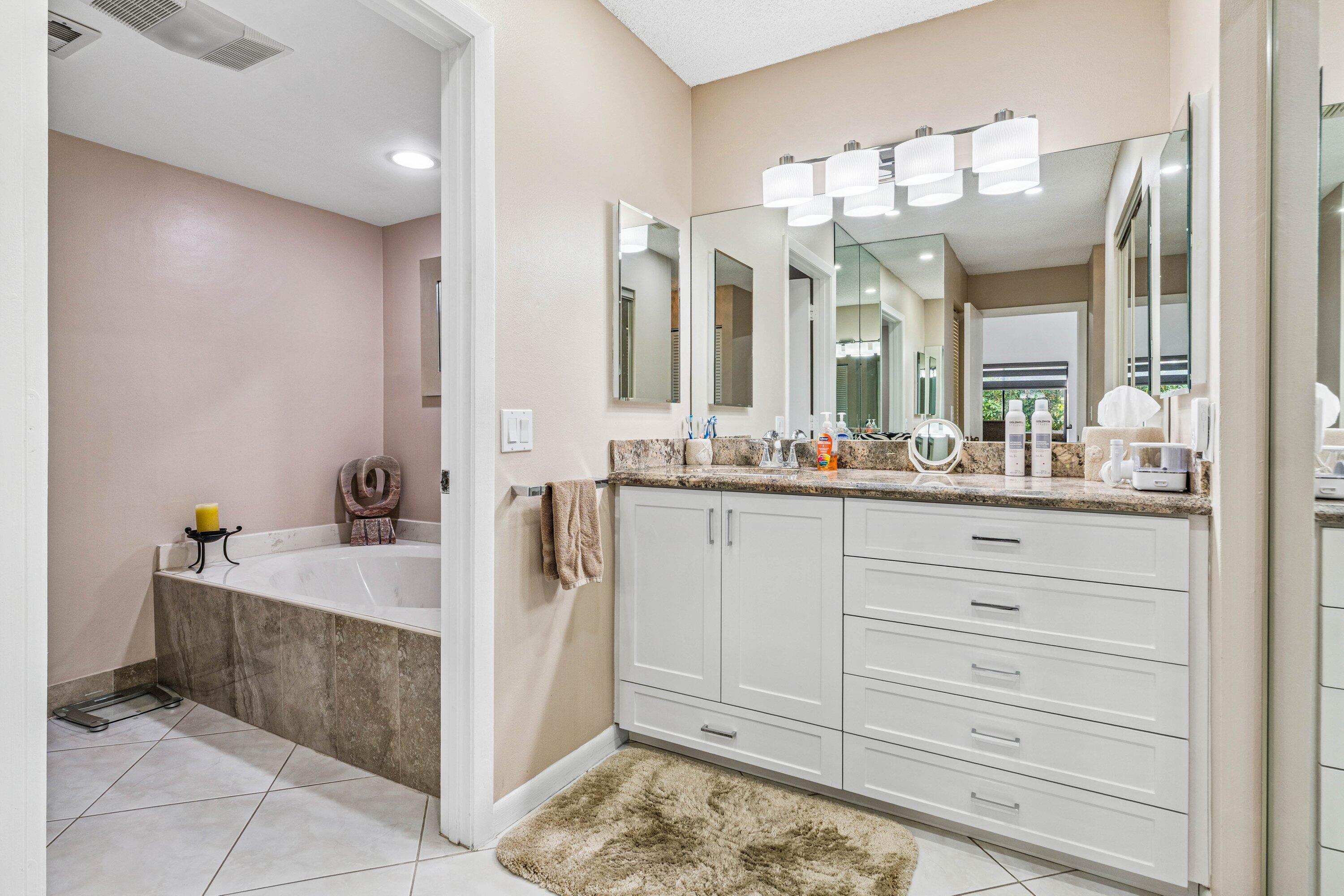 21720 Arriba Real, Unit 37B Boca Raton, FL 33433 - Photo 31 of 41 a bathroom with a sink a large mirror and a shower