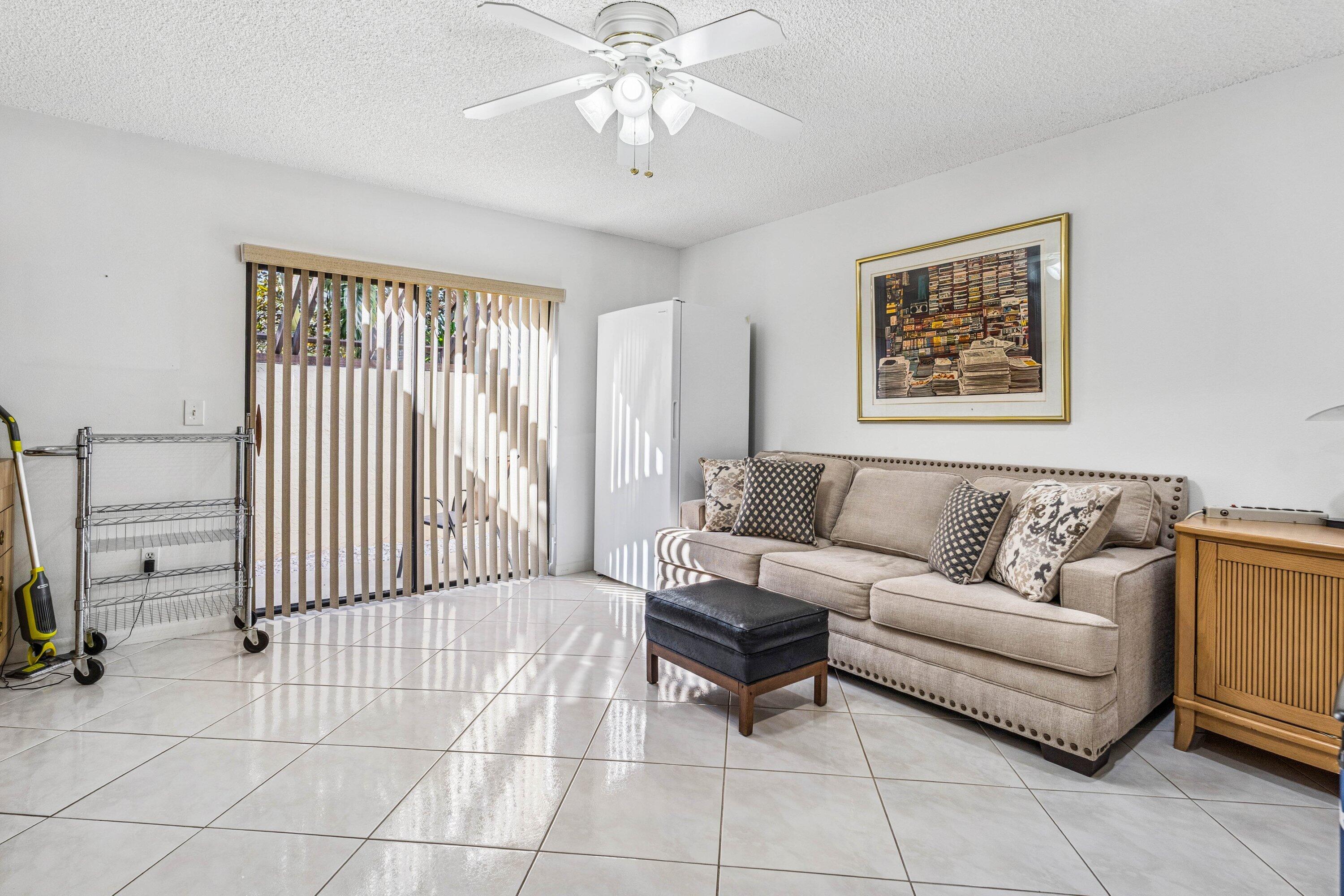 21720 Arriba Real, Unit 37B Boca Raton, FL 33433 - Photo 33 of 41 a living room with furniture and a flat screen tv