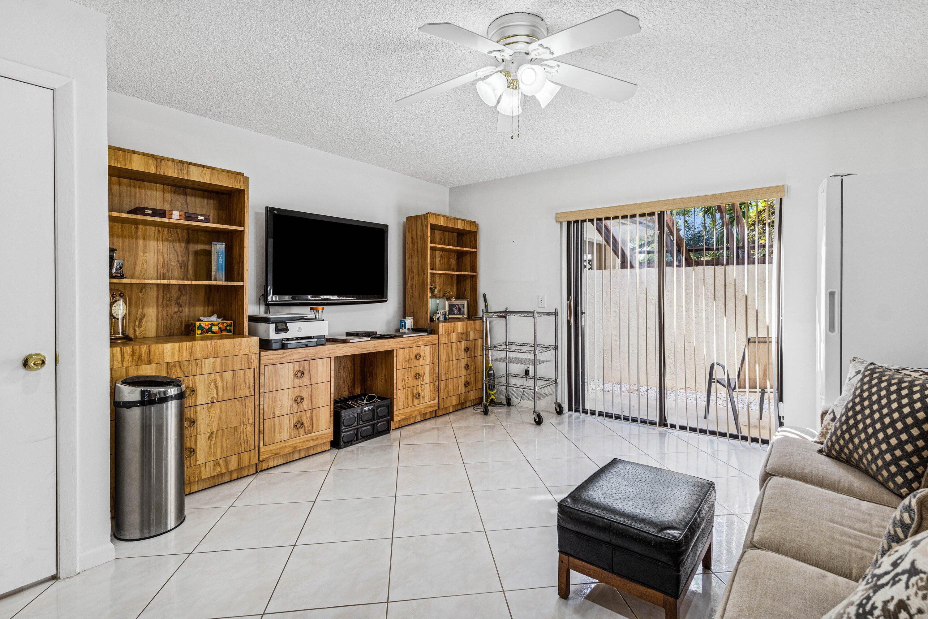 21720 Arriba Real, Unit 37B Boca Raton, FL 33433 - Photo 34 of 41 a room with furniture a flat screen tv and a window