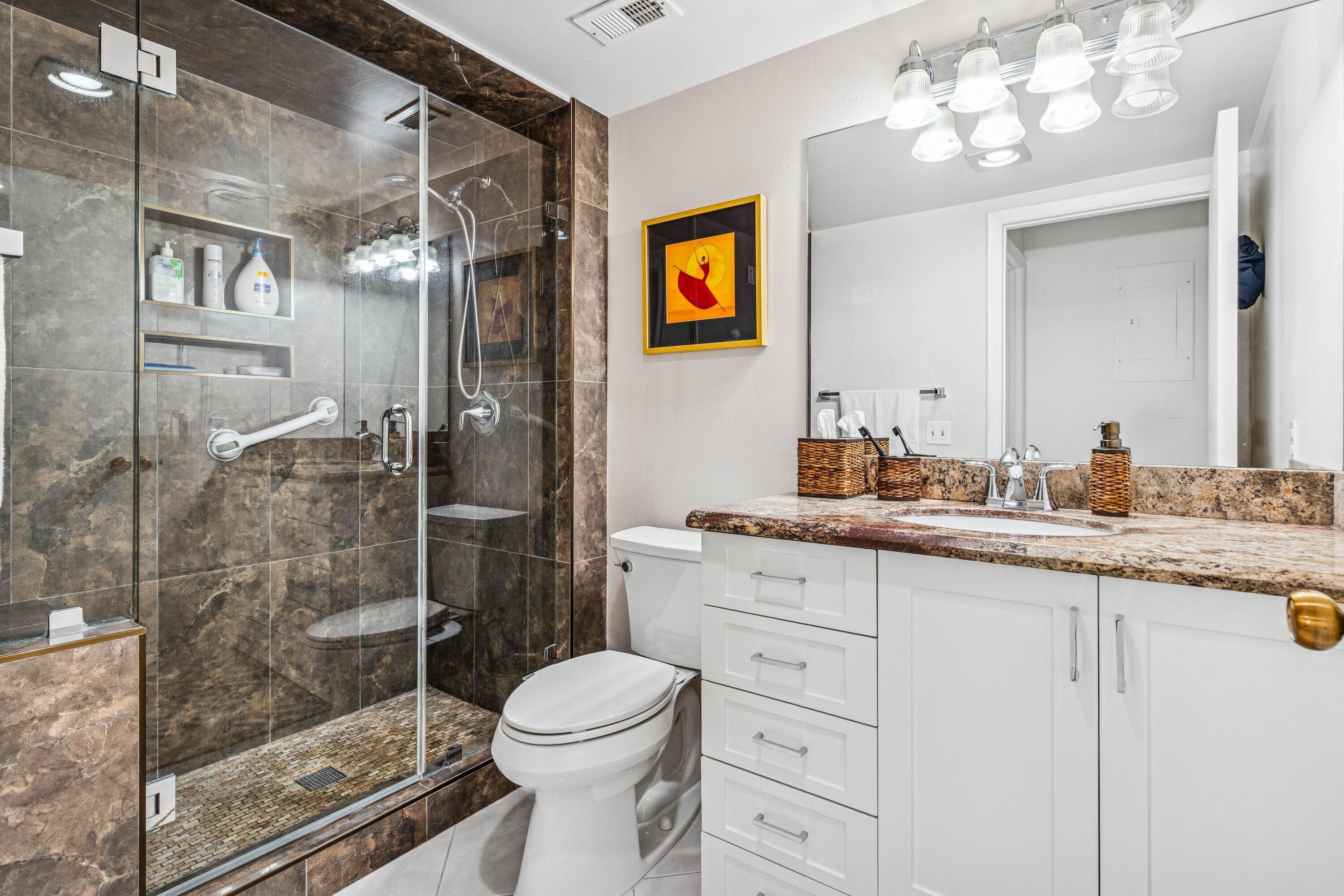 21720 Arriba Real, Unit 37B Boca Raton, FL 33433 - Photo 35 of 41 a bathroom with a granite countertop sink a toilet and shower