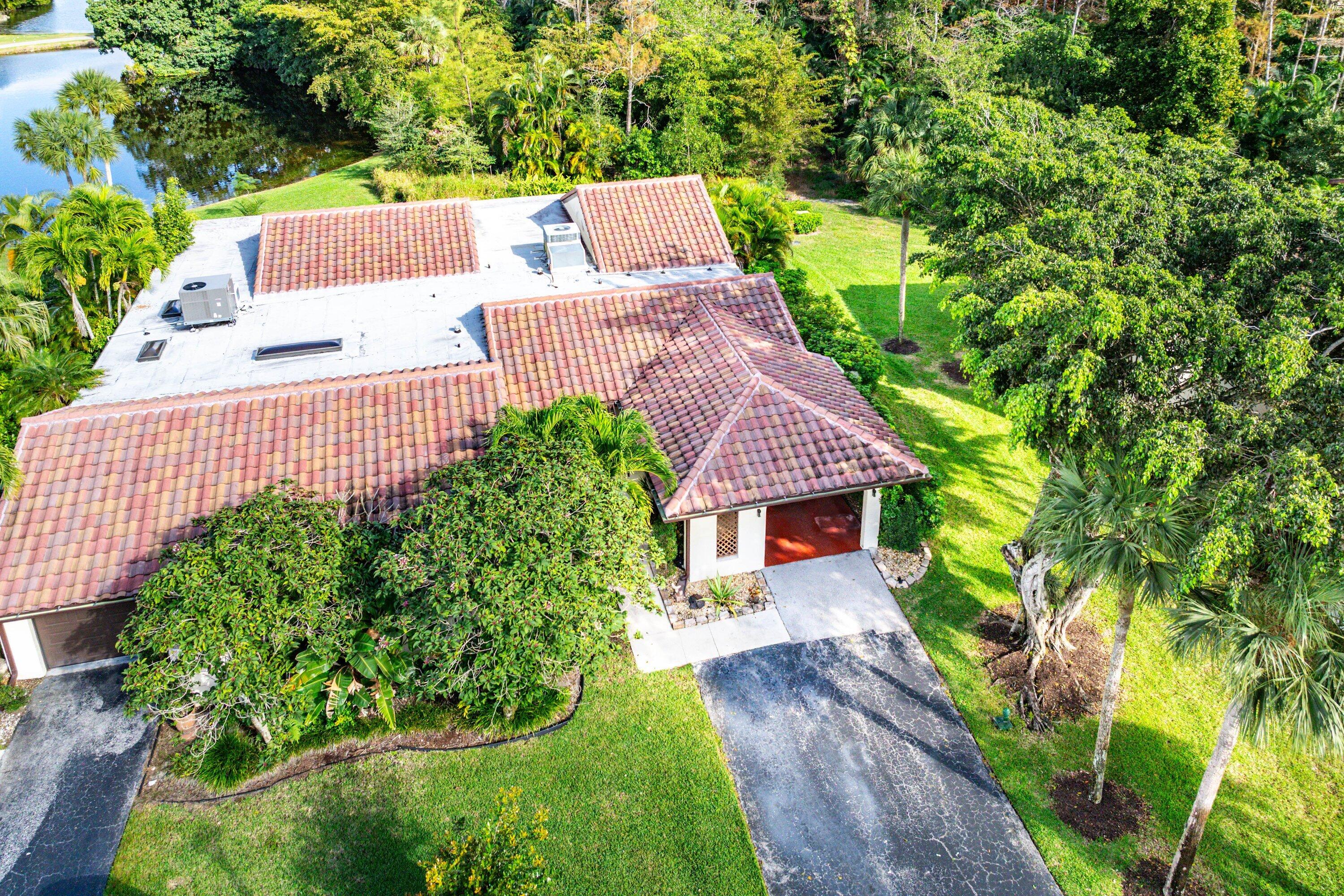 21720 Arriba Real, Unit 37B Boca Raton, FL 33433 - Photo 36 of 41 a view of house with garden and trees