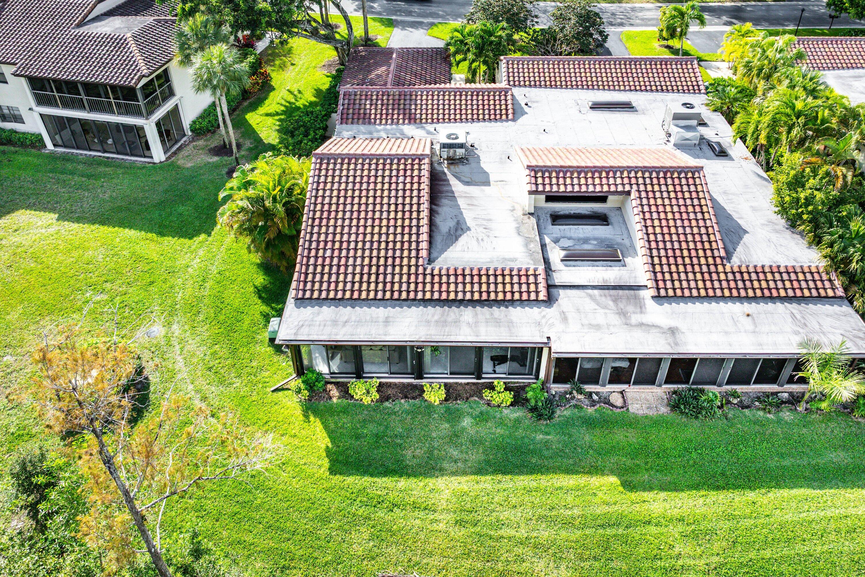 21720 Arriba Real, Unit 37B Boca Raton, FL 33433 - Photo 38 of 41 a front view of a house with a yard