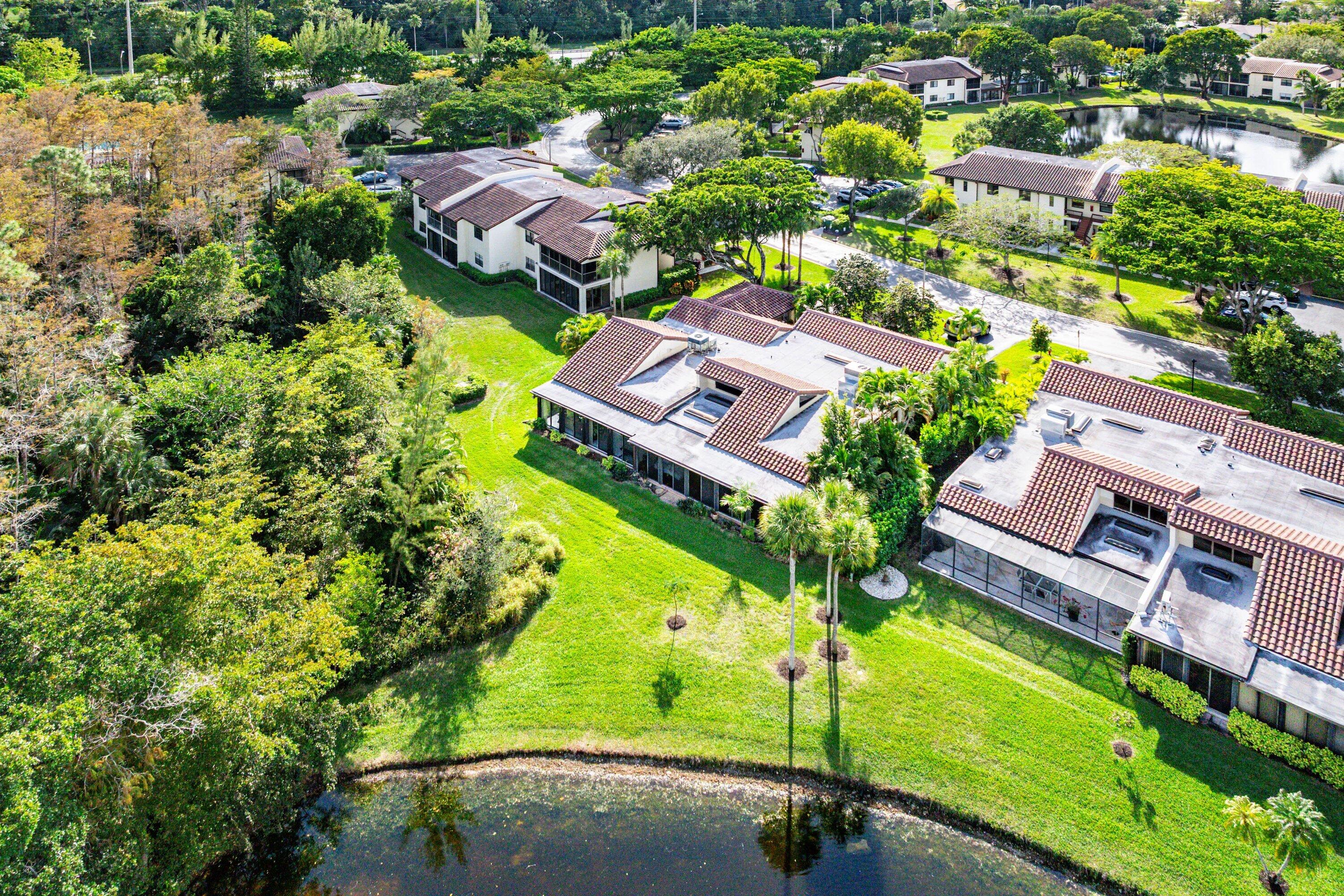 21720 Arriba Real, Unit 37B Boca Raton, FL 33433 - Photo 39 of 41 an aerial view of a house with a garden and swimming pool