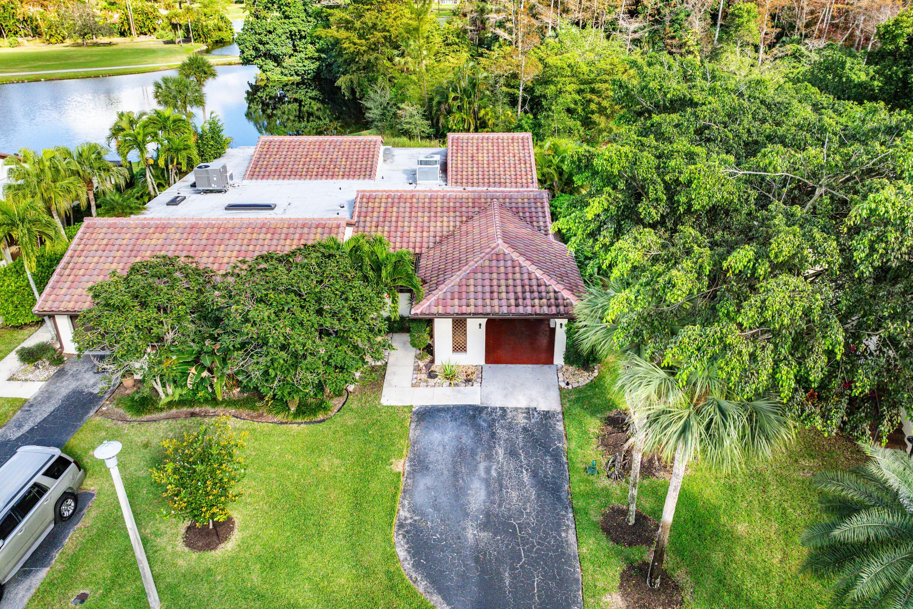 21720 Arriba Real, Unit 37B Boca Raton, FL 33433 - Photo 5 of 41 an aerial view of a house with a yard and lake view