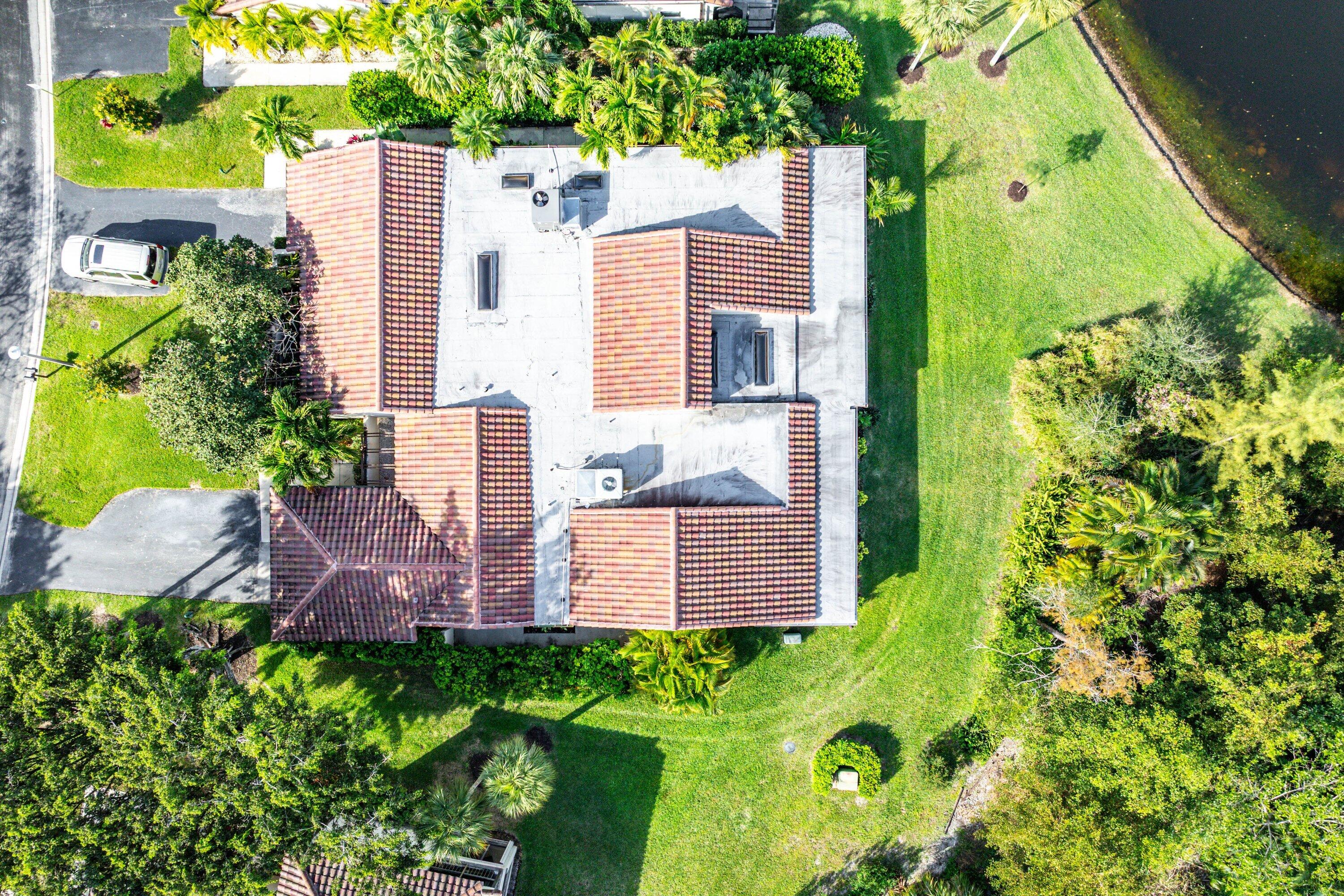 21720 Arriba Real, Unit 37B Boca Raton, FL 33433 - Photo 6 of 41 an aerial view of a house with swimming pool and garden
