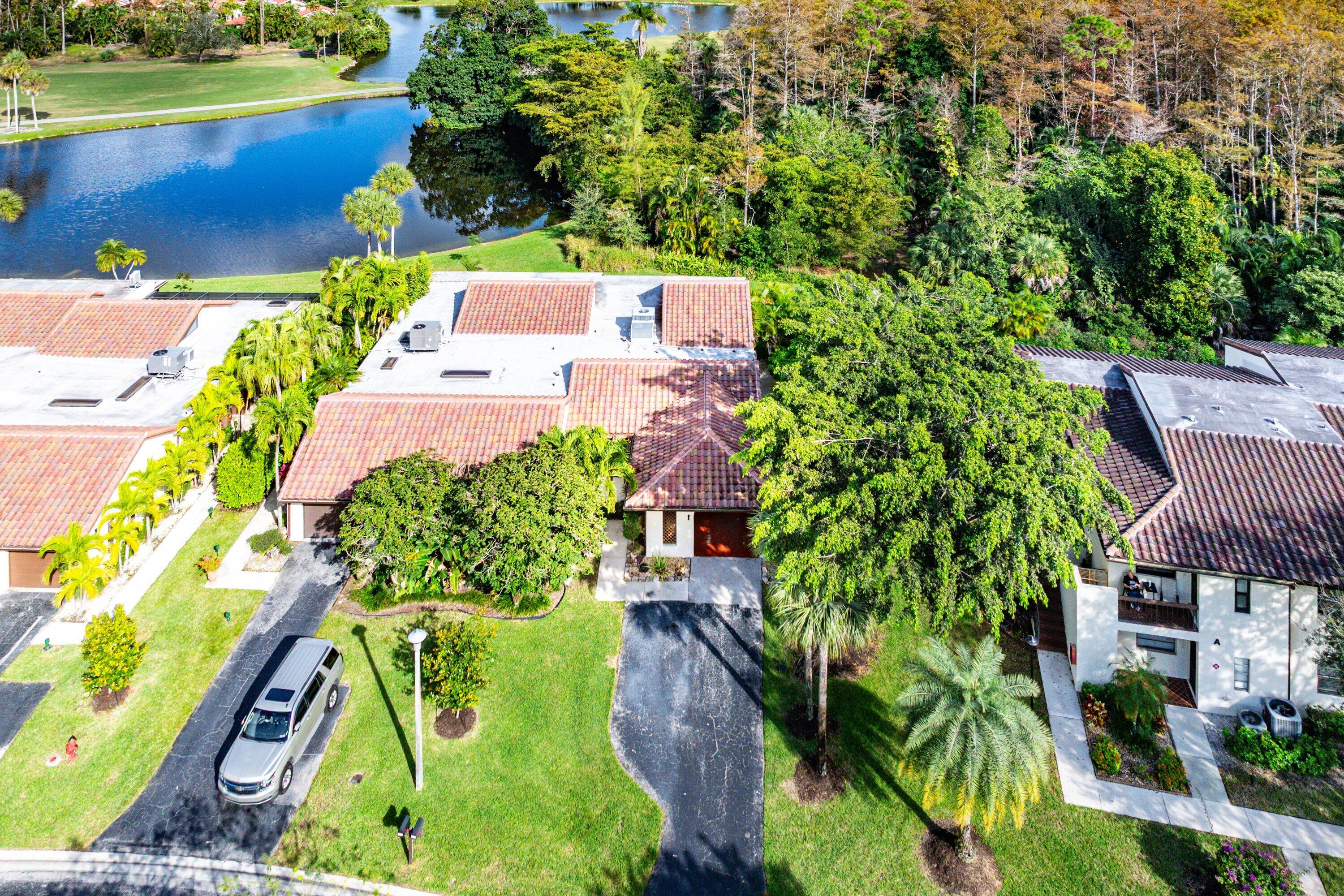 21720 Arriba Real, Unit 37B Boca Raton, FL 33433 - Photo 7 of 41 an aerial view of a house with a garden and lake view