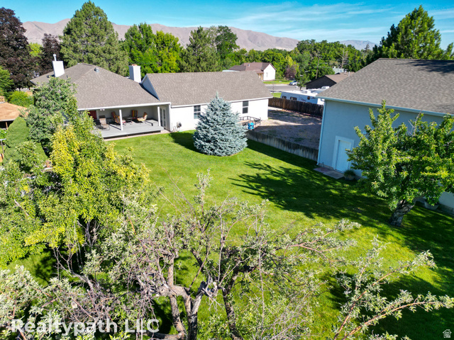 475 South 300 East Payson, UT 84651 - Photo 11 of 12 Spacious backyard featuring a manicured lawn, established trees, and a covered porch