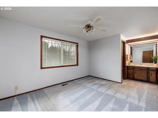 a view of an empty room with a fan