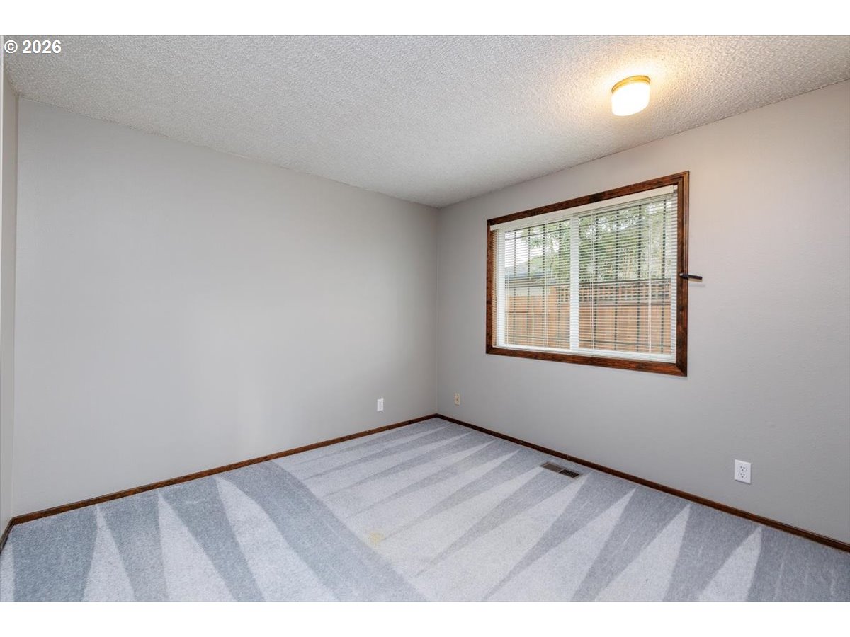 12790 Southwest Cleveland Bay Lane Beaverton, OR 97008 - Photo 19 of 32 a view of an empty room with a window