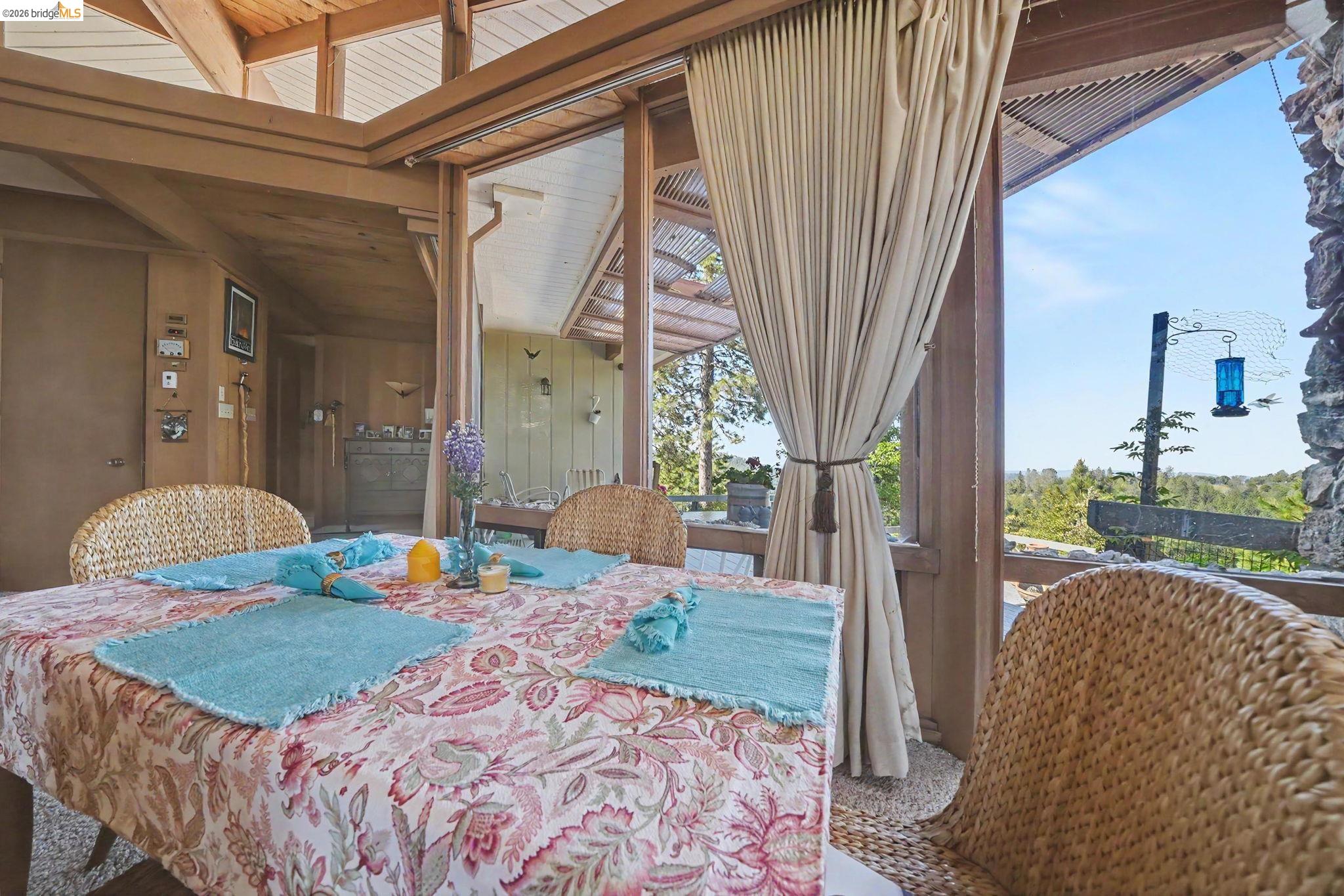 6161 Fullen Road Murphys, CA 95247 - Photo 22 of 53 a bedroom with a bed a lamp and a large window with garden view
