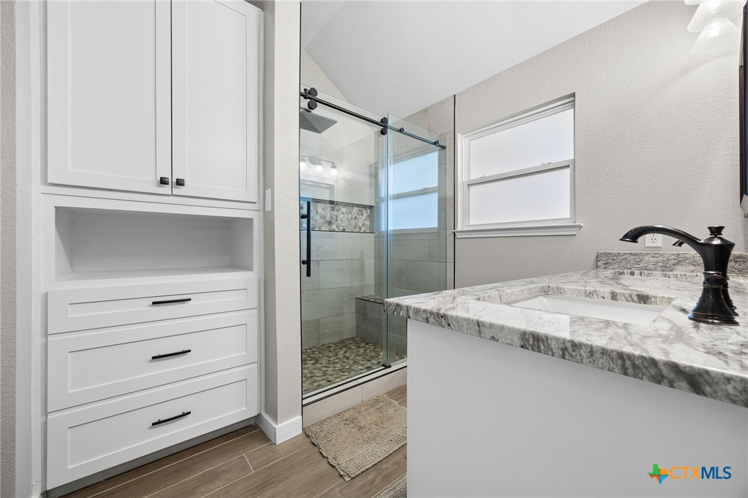 910 Neuberry Cliffe Temple, TX 76502 - Photo 17 of 32 a bathroom with a granite countertop sink and a mirror