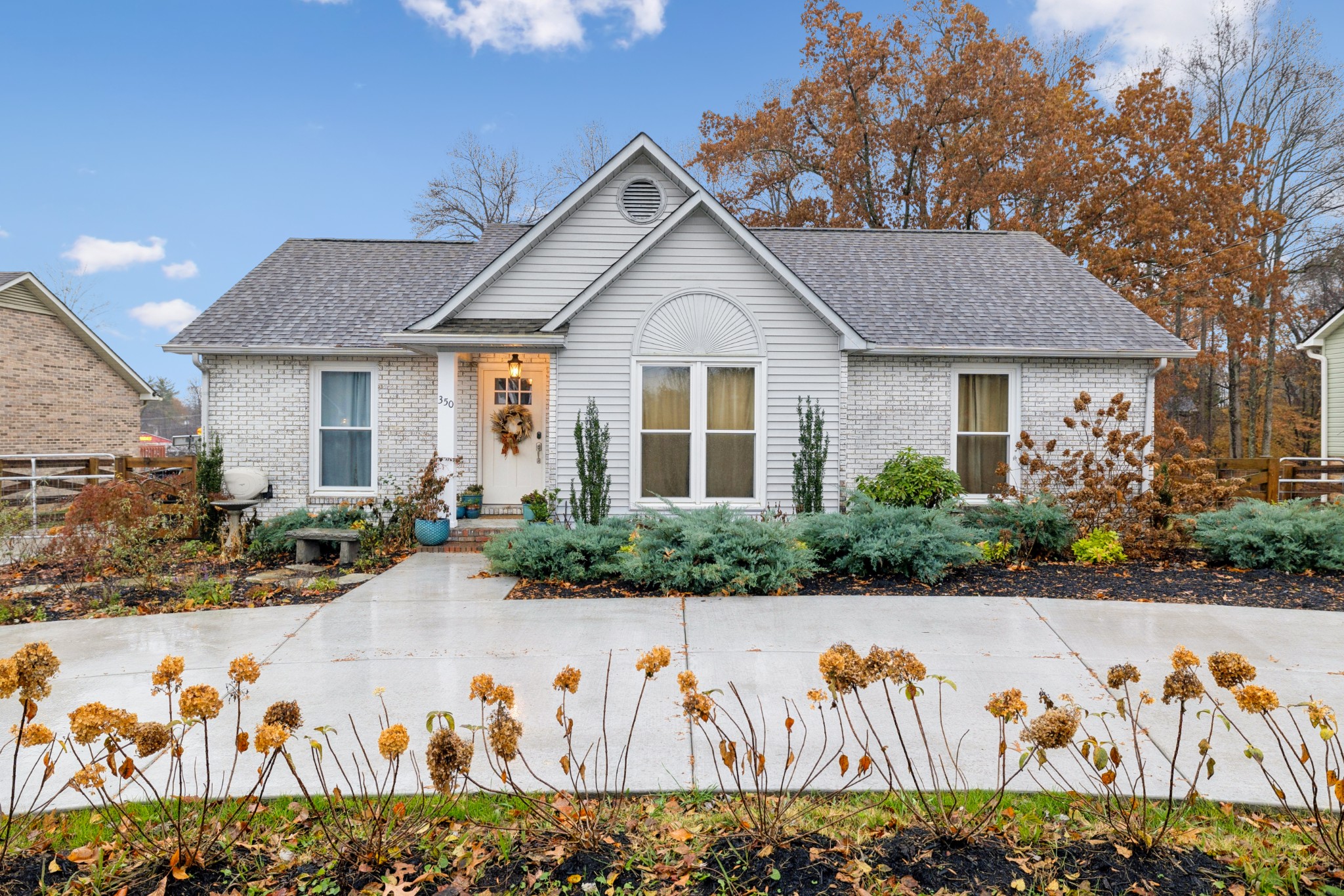 a front view of a house with lots of flowers