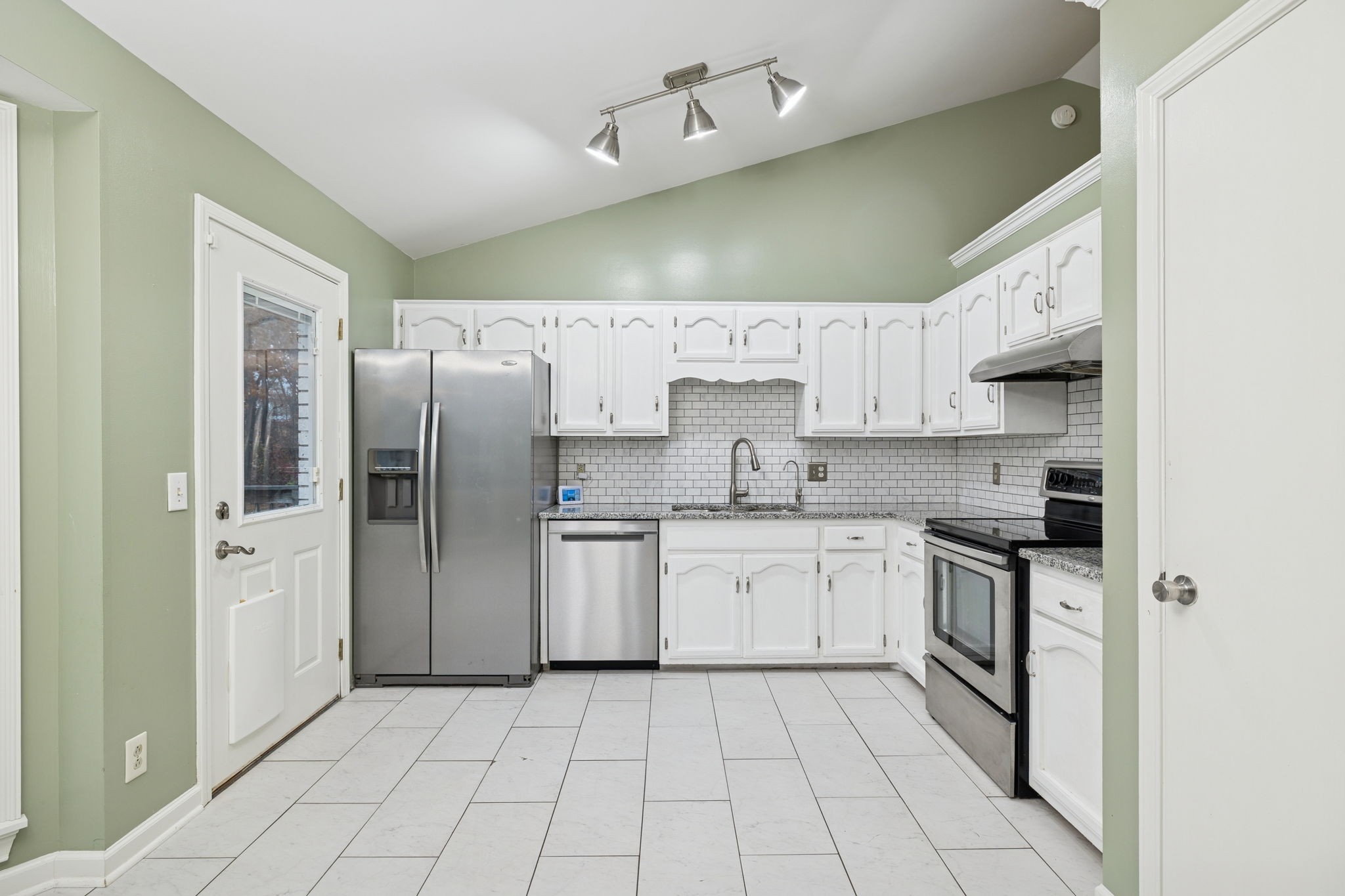 350 State Street Cookeville, TN 38501 - Photo 17 of 44 a kitchen with stainless steel appliances granite countertop a sink a stove a refrigerator and cabinets