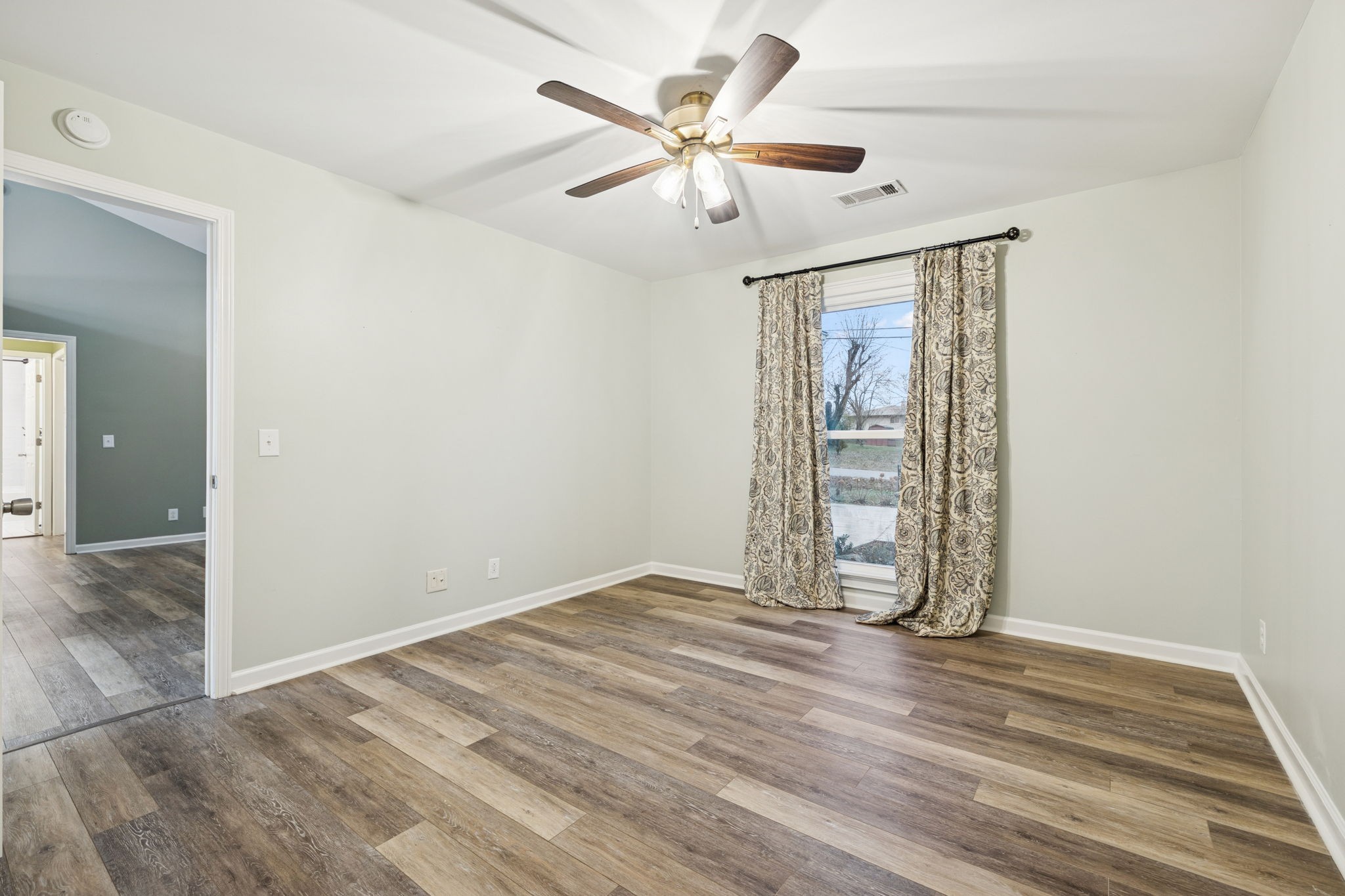 350 State Street Cookeville, TN 38501 - Photo 25 of 44 an empty room with wooden floor and ceiling fan