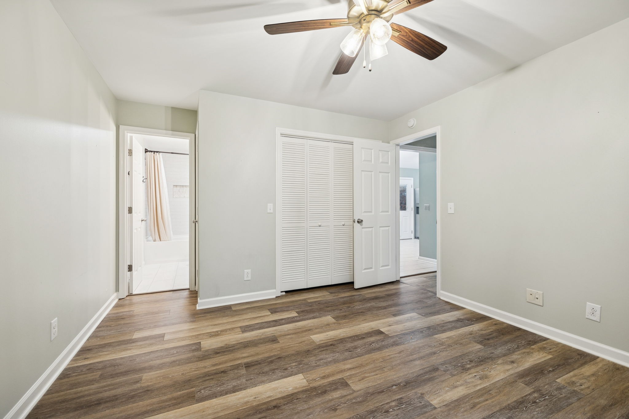 350 State Street Cookeville, TN 38501 - Photo 27 of 44 an empty room with wooden floor ceiling fan and windows