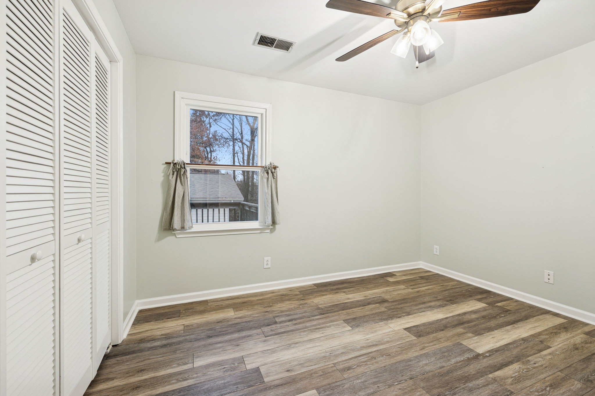 350 State Street Cookeville, TN 38501 - Photo 35 of 44 a view of an empty room with a window and wooden floor