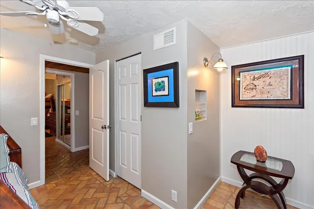 a view of a hallway with wooden floor and workspace