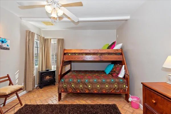 a bedroom with a bed and a window