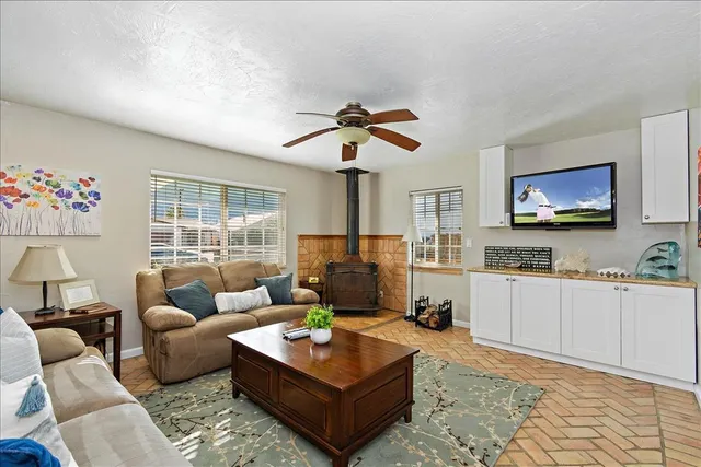 a living room with furniture a flat screen tv and a fireplace