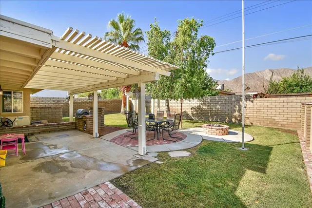 a view of a patio with table and chairs potted plants with wooden fence