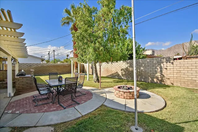 a view of a backyard with sitting area