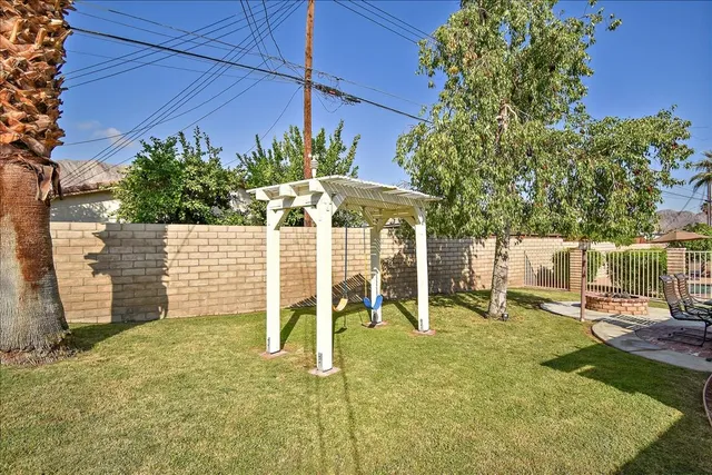 a view of a chairs and table in backyard