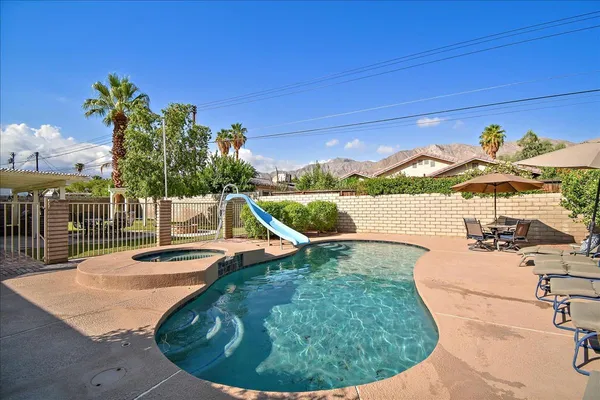 a view of a swimming pool with a lounge chair