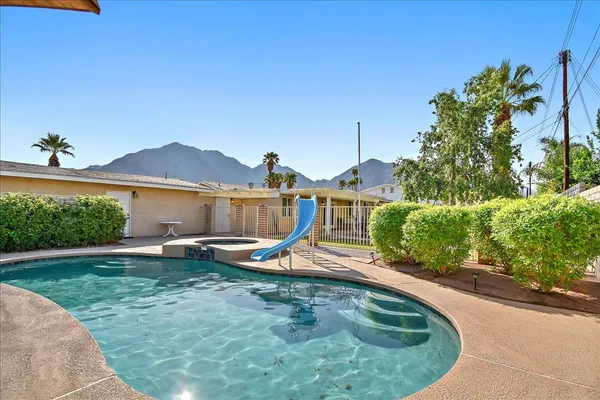 a view of a swimming pool with lounge chairs