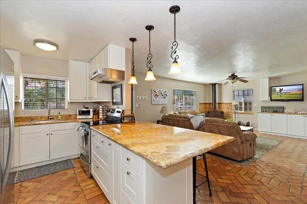 a kitchen with stainless steel appliances granite countertop a sink and cabinets