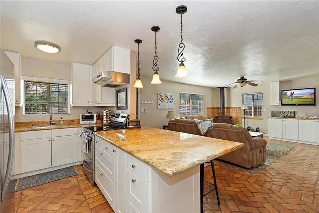 a kitchen with stainless steel appliances granite countertop a sink and cabinets